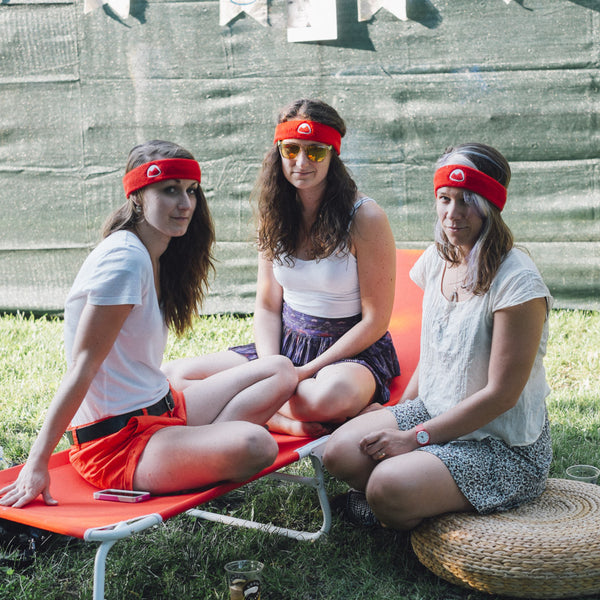 three women wearing red headbands